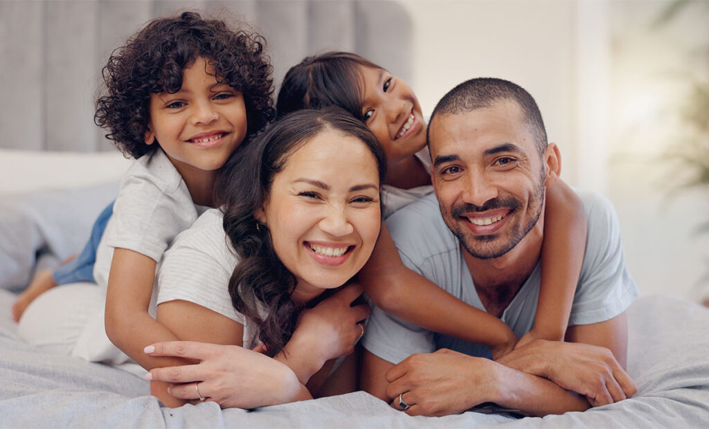 Happy family relaxing on bed